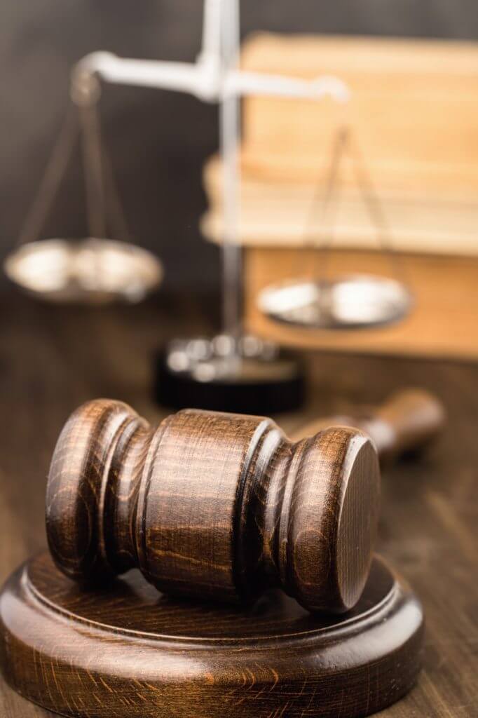 Wooden gavel with scales and books